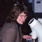 Cindy looking into a microscope