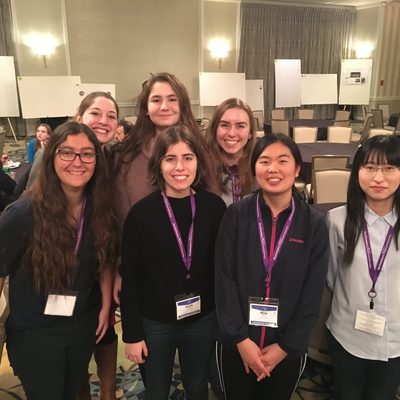 Seven students at an academic conference