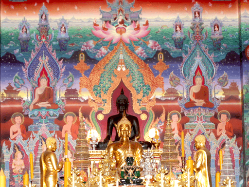 photograph of temple wall with Buddhist art and alter in foreground