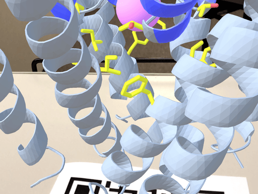 3d model of molecule appears above QR code on a plain table.