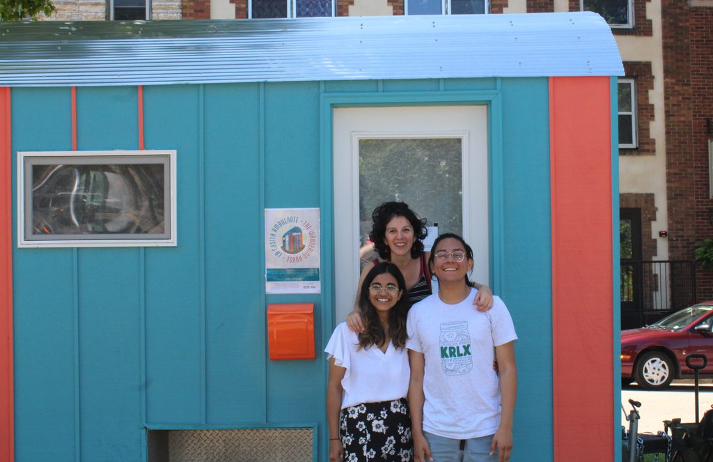 Professor Cornejo with student researchers in front of The Wandering House, a ice fishing house converted into an audio recording studio.