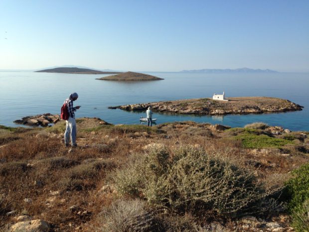 The Small Cycladic Islands Project Field Season 2019. Two people survey an island, with several other islands in the distance