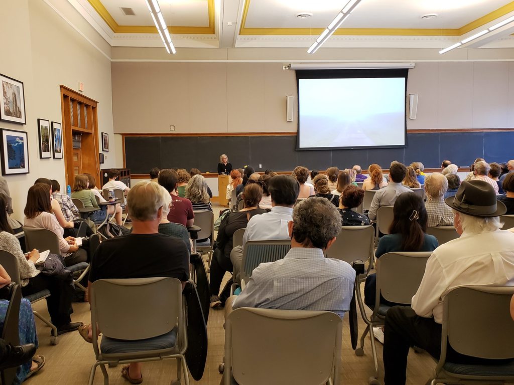 Gwen Westerman stands in front of an audience while presenting her keynote address