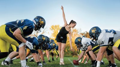 Carolyn Friedhoff performs ballet between the lines during a football scrimmage