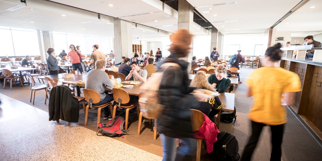 Students eat in a busy dining hall