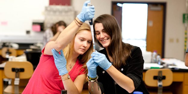 Two students collaborate in a science lab