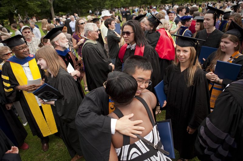 New grads hug Carleton faculty and staff after commencement