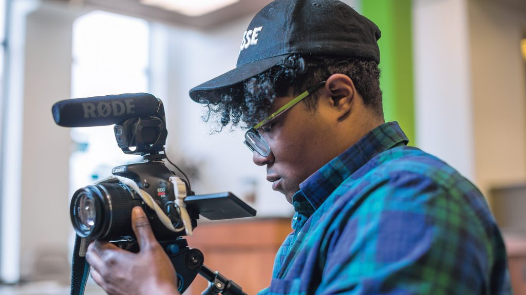 Filmmaker Brit Fryer ’15 adjusts his video camera