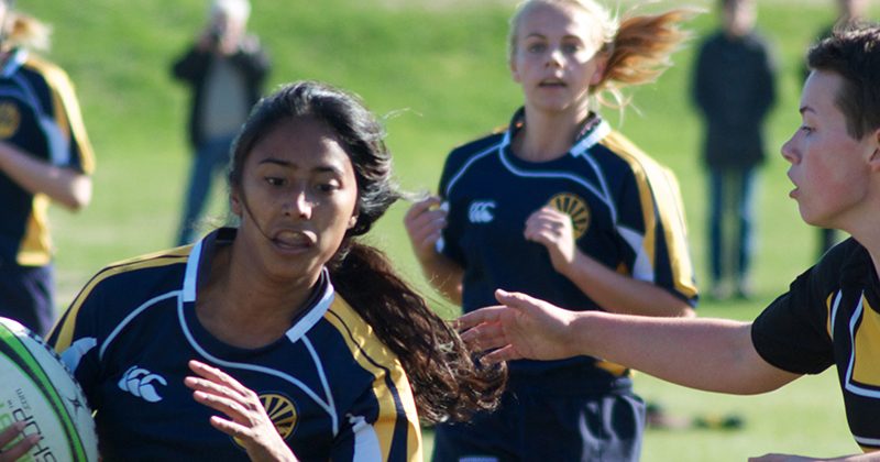 A student navigates the rugby pitch