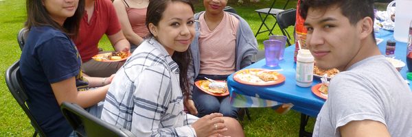 A group of students enjoys a picnic outdoors