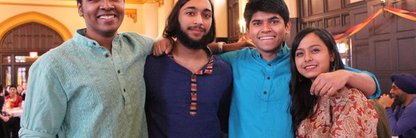 Four students in traditional South Asian clothing