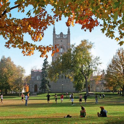 Students gather on the Carleton Bald Spot on an autum day