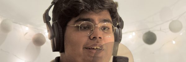 A young man sings into a microphone