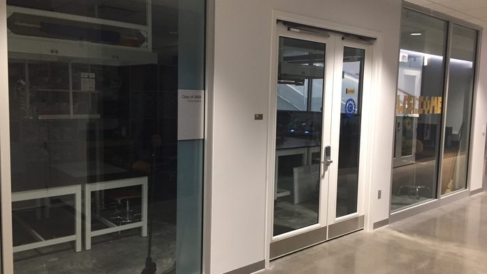 An dark, empty room in an empty hallway