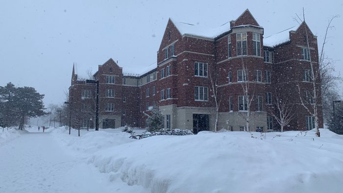Cassat Hall from outside, covered in falling snow