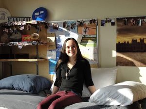 McKenna sitting on her bed in Myers