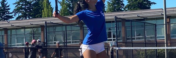 A photo of Amelia Asfaw serving a tennis ball