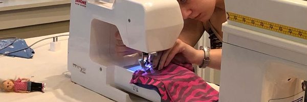A photo of Cassidy Goldman using a sewing machine