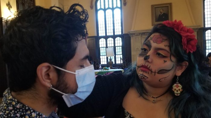 A Student Paints the Face of Another