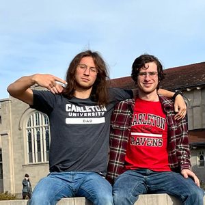 Two guys posing with their Carleton University shirts
