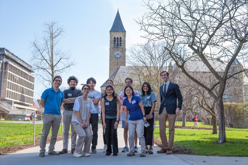 The in-person presenters at CULC16 pose for a picture outside Cornell's clock tower.