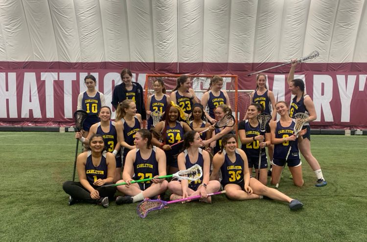 Women's lacrosse team taking a team photo with silly faces at St Mary's Dome