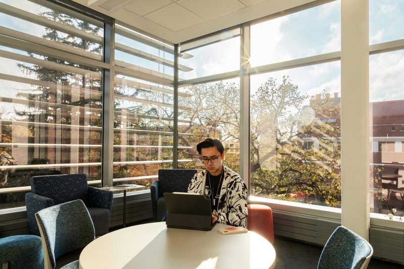 student on laptop in study room