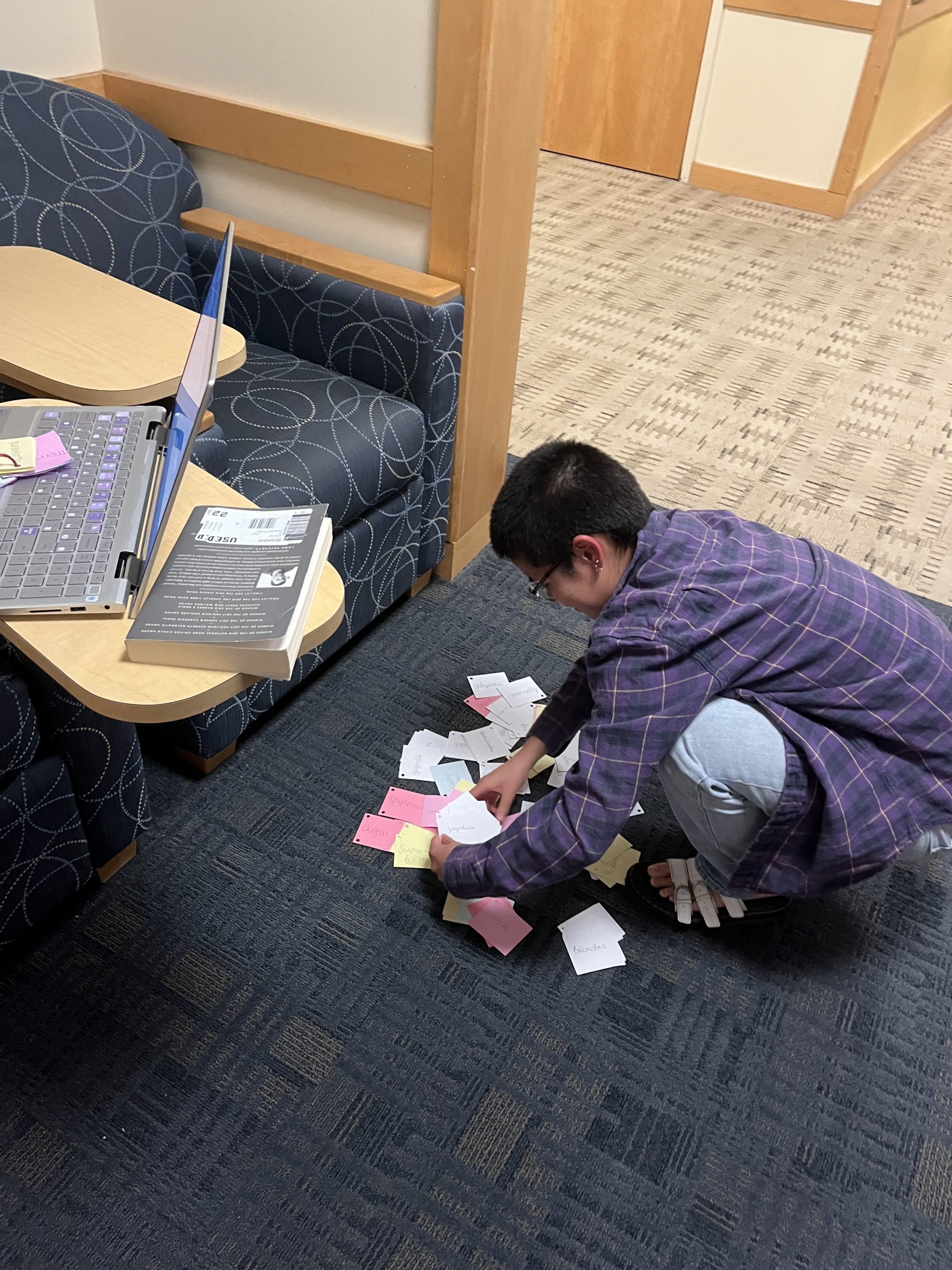 Student picks up flashcards from the floor