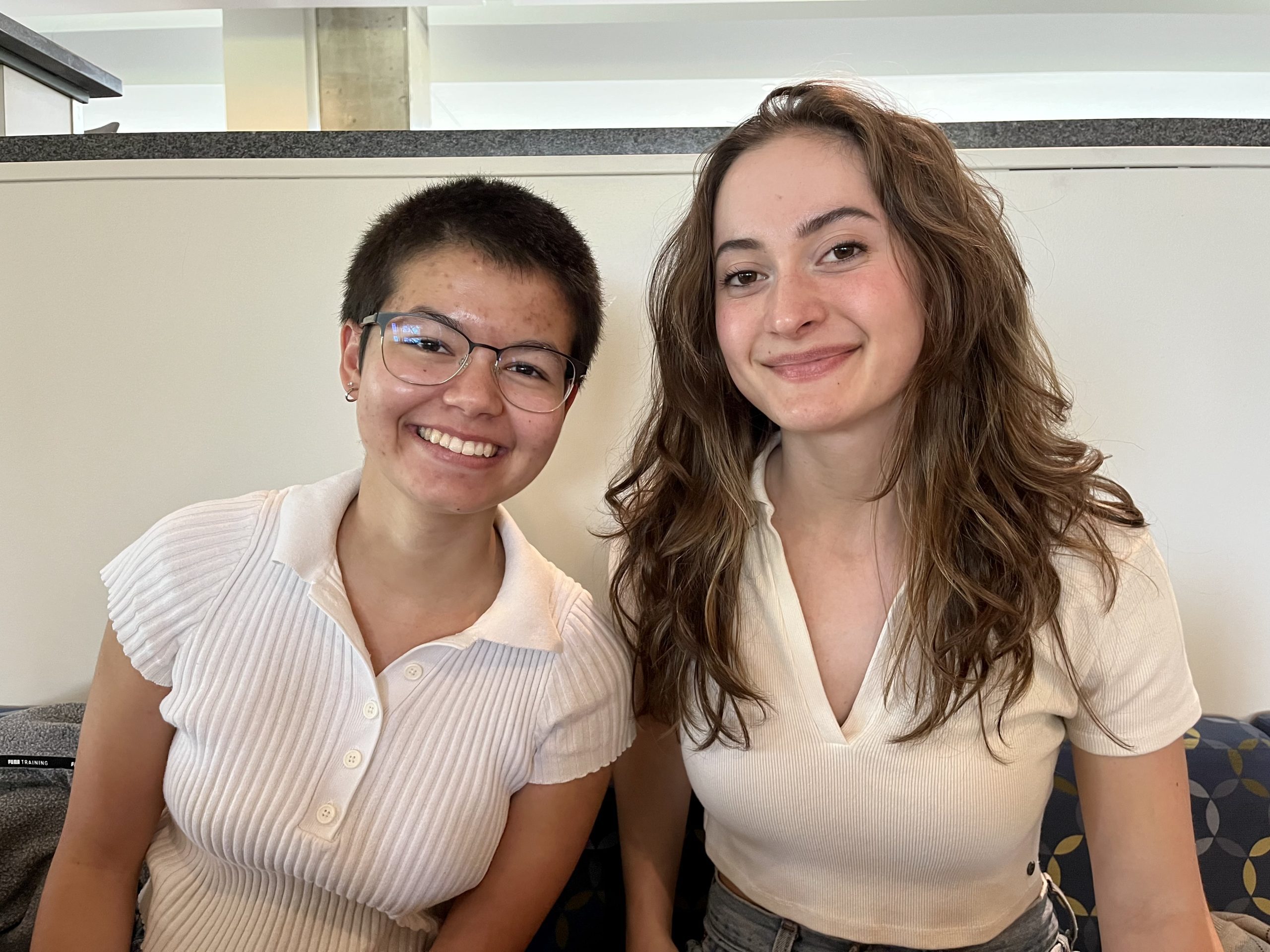 Two students smile
