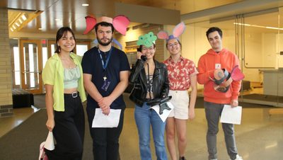 Students with animal hats smile