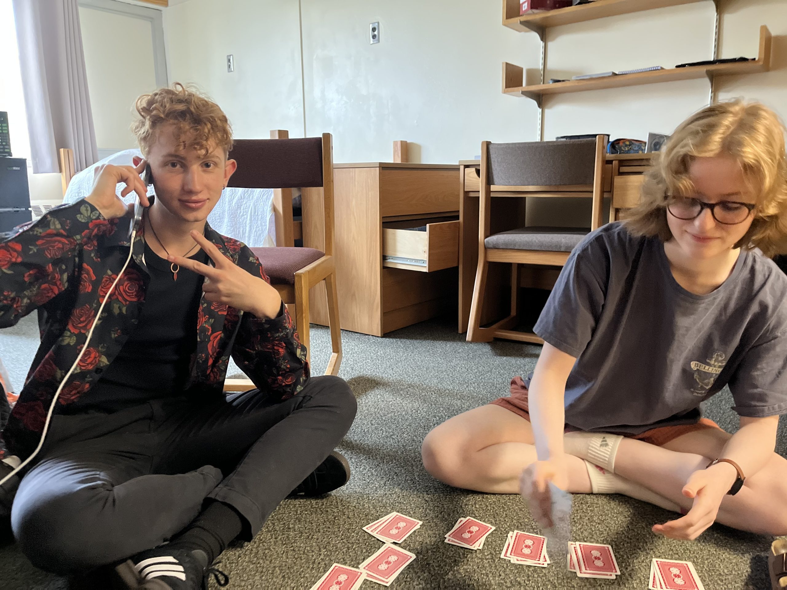 Two students play with a deck of cards