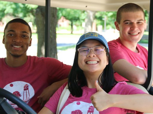 Program and Community Assistants on a golf cart