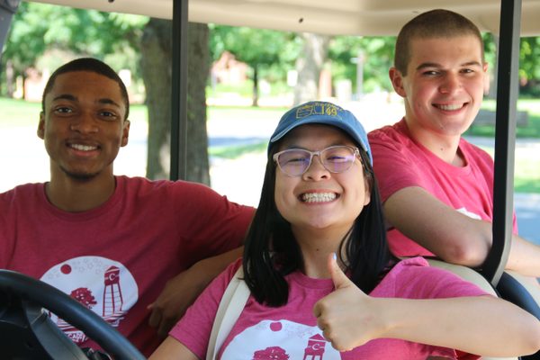 Program and Community Assistants on a golf cart