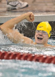 swimmer celebrating a win in the pool