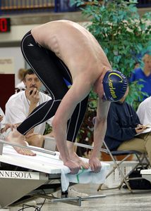 swimmer about to dive into the water for a race