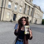Hannah holding up a map from Mapping Dubliners and also her copy of Dubliners