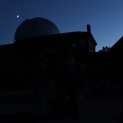 A crescent moon above Goodsell Observatory July 2015