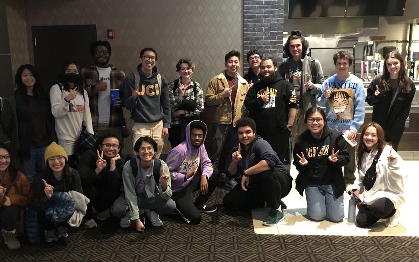 A large group of students posing together at the movie theater