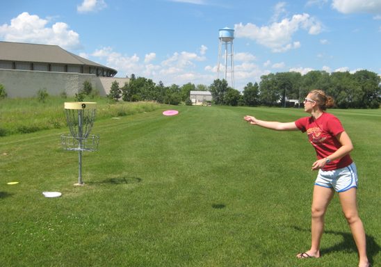 A student plays disc golf