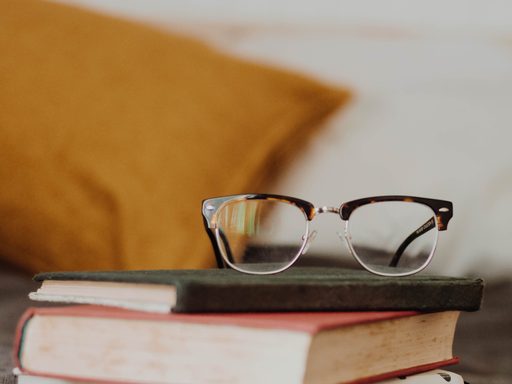 A pair of glasses on a stack of books