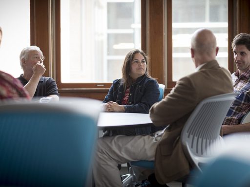 Five professors sitting around a table