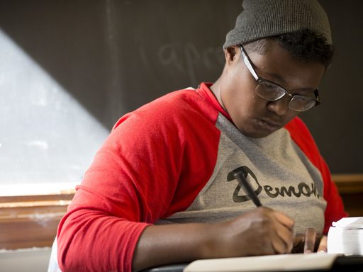 Student writes in classroom