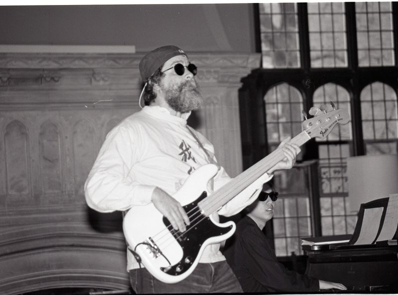 Mark playing guitar wearing cool shades.