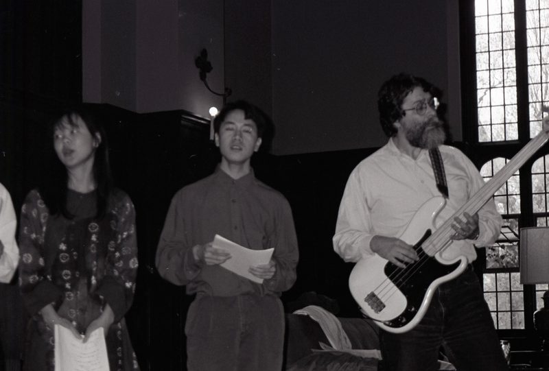 Two students sing while Mark Plays guitar.