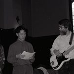 Two students perform with Mark playing guitar.
