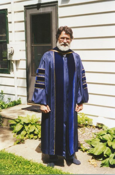 Mark Hansell poses in his academic robe.