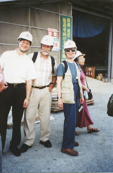 Four faculty wearing hard hats on trip to Asia.