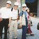 Four faculty wearing hard hats on trip to Asia.