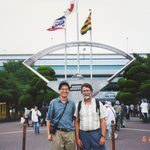 Two people posing outside the Hanshien Koshien Stadium