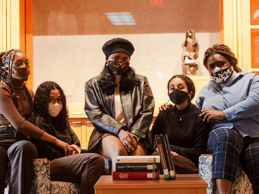Five women wearing masks